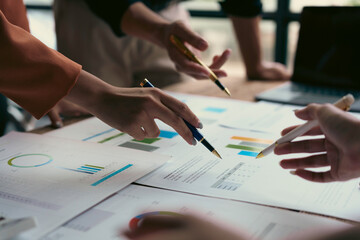 Business team analyzing financial data and investment strategy planning using charts and graphs during a meeting