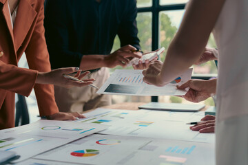 Fototapeta premium Business team analyzing financial charts and graphs, developing growth strategies and discussing company performance