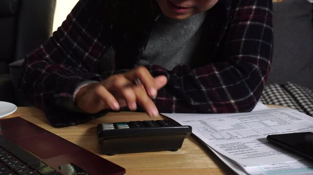 Budget and Tax planning concept. Acountant hand using calculator and review tax form. Represents personal finance, tax preparation, budgeting, and season to pay tax.