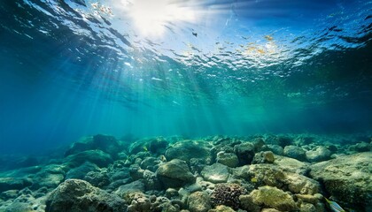 Naklejka premium Tranquil underwater scene with sunlight rays piercing the deep blue ocean