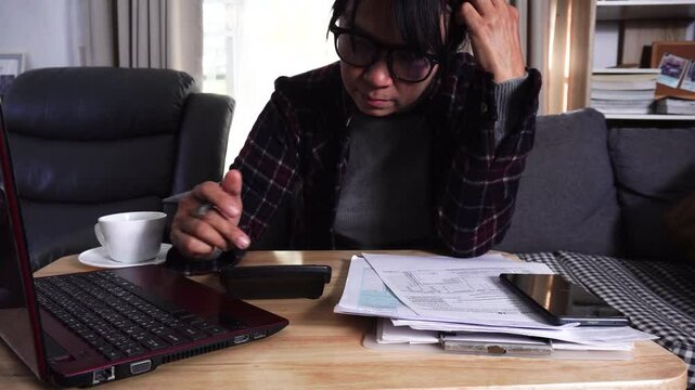 Budget and Tax planning concept. Accountant hand using calculator and review tax forms. Represents personal finance, tax preparation, budgeting, and season to pay tax.