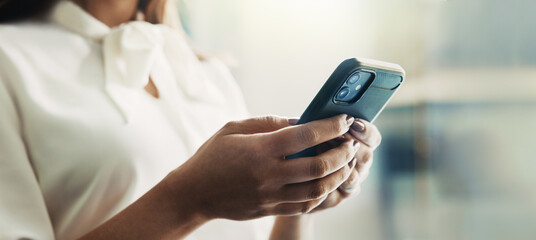 Business, woman and hands typing with smartphone in office for cryptocurrency research and reading stock market news. Professional, trader and phone for checking trading account and online investment