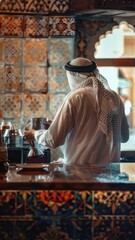 Arab man in traditional clothes serving coffee in a cafe