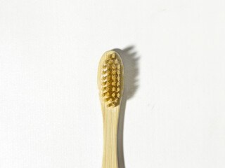 Eco-friendly dental health wooden toothbrush on a white background. Close up view in the studio.