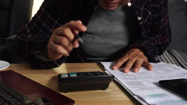 Budget and Tax planning concept. Acountant hand using calculator and review tax form. Represents personal finance, tax preparation, budgeting, and season to pay tax.