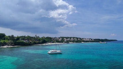 Scenic Coastal Resort with Yacht on Turquoise Waters