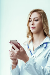 Doctor using smartphone and reading medical news in hospital