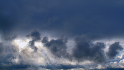 Summer evening sky in the picturesque clouds, lit by the rays of the setting sun.