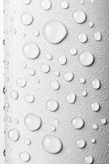 Close-up of water droplets on a sleek metallic surface, showcasing a refreshing and clean aesthetic.