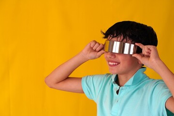 preteen boy smiling with futuristic modern metallized glasses