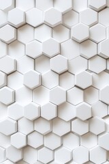 Naklejka premium Textured white hexagonal tiles create a sleek and modern wall design perfect for contemporary interiors.