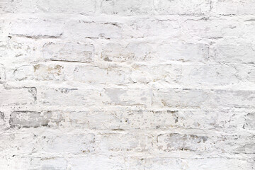 The texture of an old brick wall with whitewash. A white rough brick wall.