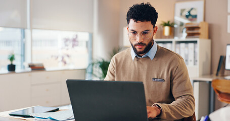 Doctor, man and typing on laptop in clinic for checking patient information, medical records or...