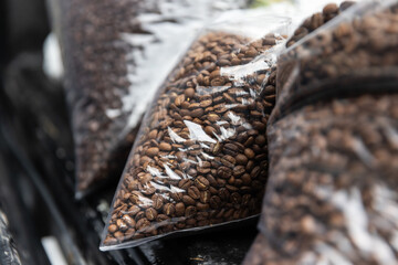 Medium-Roast Coffee Beans in a Clear Plastic Bag, Carefully Packaged to Maintain Freshness, Aroma, and Quality for Specialty Brewing, Ensuring Perfect Flavor Extraction in Every Cup, Ideal for Enthusi