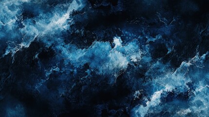 Fototapeta premium Abstract blue and black swirling patterns resembling waves or clouds.