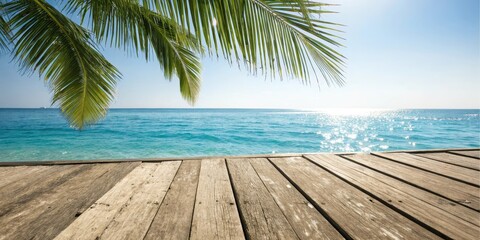 Serene ocean view from a weathered wooden dock, partially shaded by lush palm fronds under a bright sun