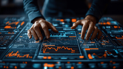 person interacting with futuristic digital interface displaying data analytics and graphs. hands are positioned over glowing touchscreen with vibrant orange and blue elements