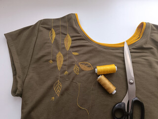 Embroidery of yellow leaves on a T-shirt. Do-it-yourself option for decorating clothes