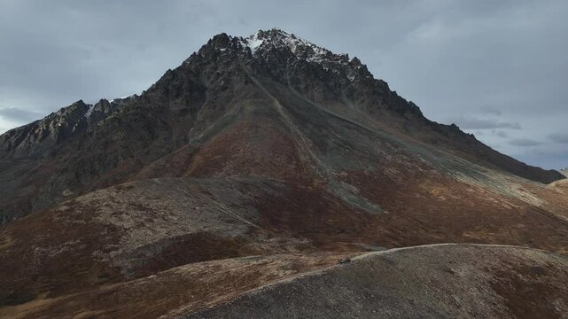Two 4WD vehicles standing on top of a rocky mountain. Drone view