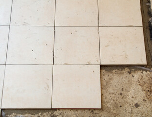 A tile floor with a few tiles missing