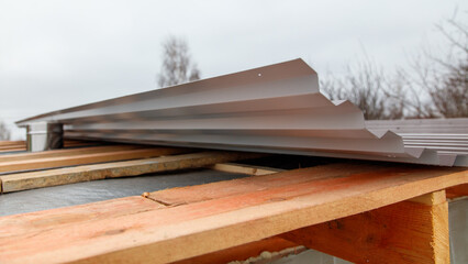 A roof is being built with a metal roofing material