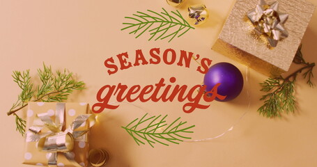 Image of christmas greetings text over christmas presents and decorations © vectorfusionart