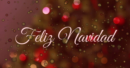 Image of yellow spots of light and feliz navidad text banner against a decorated christmas tree