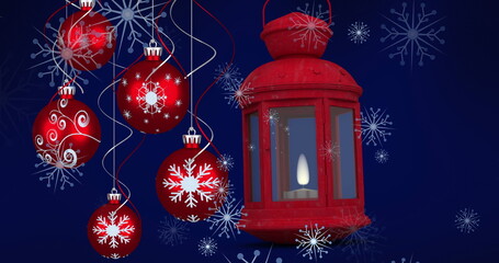 Image of red lantern and christmas baubles decorations with snow falling