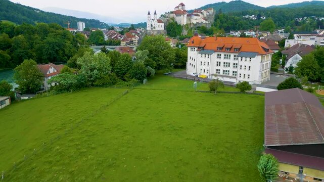 4K Drone Video of the Schule Hofmatt School on the Banks of the Beautiful Aare River as it runs through the Aare Valley in Aarburg, Switzerland