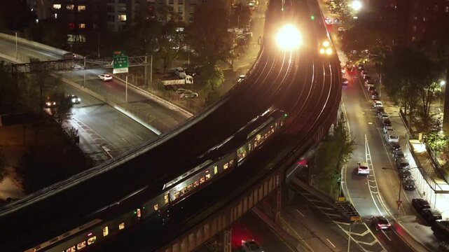 Aerial view of the Metro North Railroad leaving New York City. Shot at night.