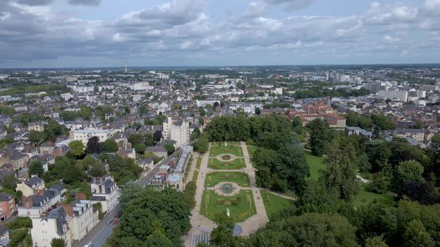 Sideways drone movement above the Parc du Thabor spiral garden and its closest environment, Rennes, France.