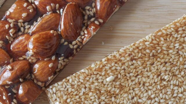 Pan left of nougat and sesame bar with honey. Guirlaches, traditional Christmas sweet from Spain.