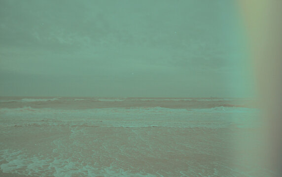 Seaside caught on 35mm film with rainbow