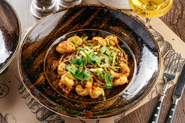 noodles with shrimp in sauce and greens