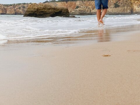 Healing walk on the beach with the waves of the sea touching the feet