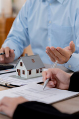 Property investment concept, Real estate broker with home insurance policy about house contract..