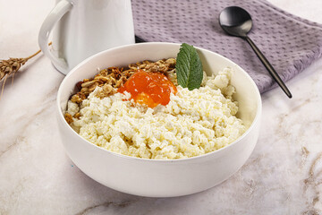 Curd with granola and orange jam