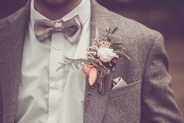 A close up of the grooms buttonhole flower on his wedding day