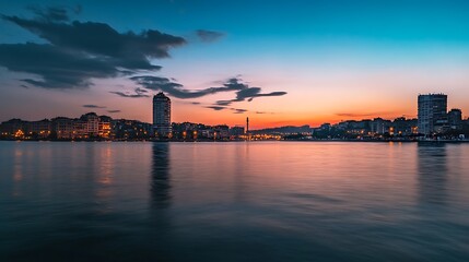 Fototapeta premium City Skyline at Sunset over River. Urban Landscape, Dusk, Reflection