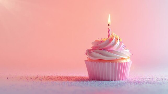 Beautiful birthday cupcake with a burning candle on it with pink pastel background for Valentines Day, Mothers Day, Birthday greeting video footage.