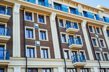 Obraz premium Detailed view of a stylish residential building in Irkutsk featuring vibrant balconies and large windows.