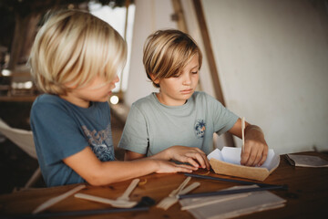 Young kids crafting at campsite with cafeteria everyday items