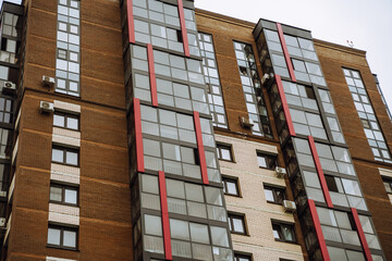 Tall residential buildings in Irkutsk highlight contemporary architecture against a cloudy sky.