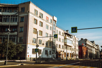 Fototapeta premium In Irkutsk, vibrant buildings line the street, creating a lively urban environment with a cozy terrace.