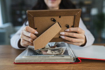 close up of woman look at photos in picture frame