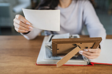 close up of woman look at photos in picture frame