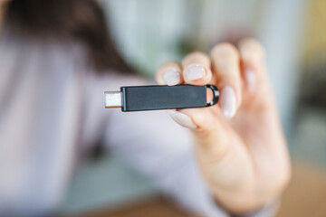 unknown woman hold usb type c at home