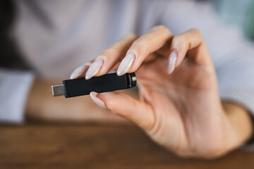 unknown woman hold usb type c at home