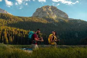 Fototapeta premium Two hikers with a scenic view behind them