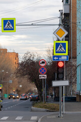 Pedestrian crossing signs on a traffic light stand at an intersection.